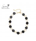 Halsketting met zwarte polkadot schakels en goudkleurige ringen